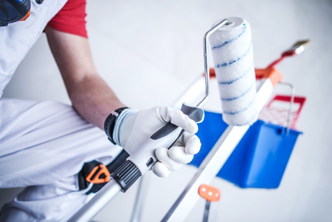 Hand holding a paint roller, close-up