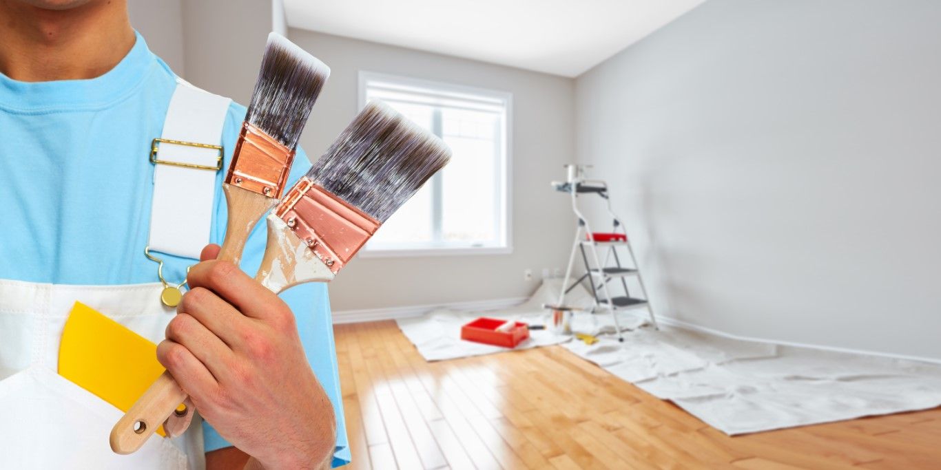 Crossed paintbrushes, tools used for exterior trim and detail work